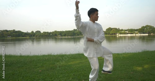 Asian man working out with Tai Chi in the morning at the park, Chinese martial arts, healthy care for life concept part13. photo