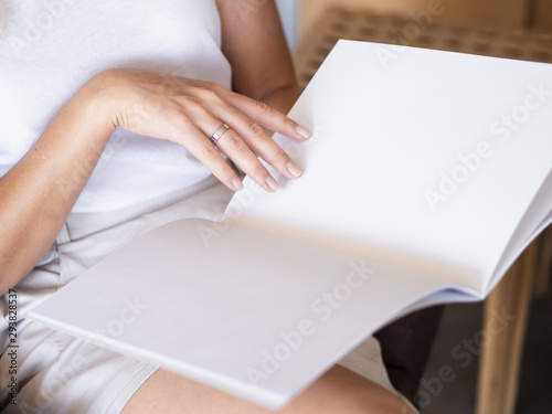Close-up woman reading a mock-up magazine
