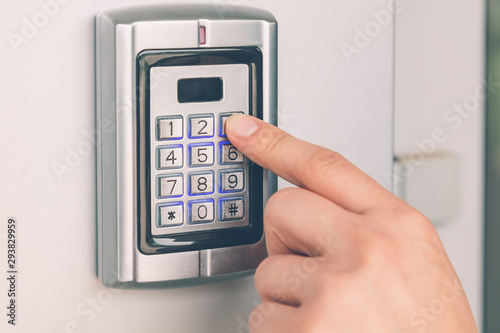 Close up of hand entering security system code