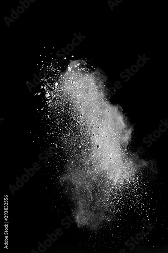 White powder splash isolated on black background. Flour sifting on a black background. Explosive powder white and vertical view.