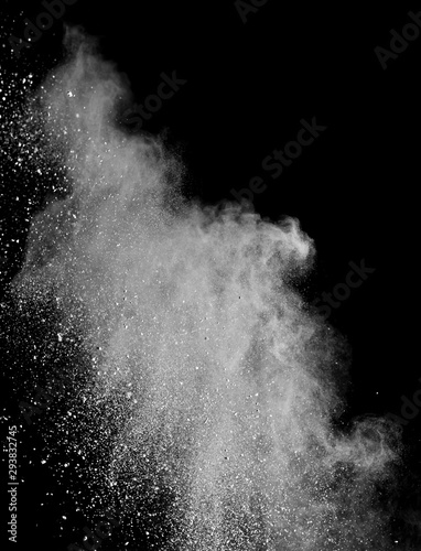 Fototapeta Naklejka Na Ścianę i Meble -  White powder splash isolated on black background. Flour sifting on a black background. Explosive powder white
