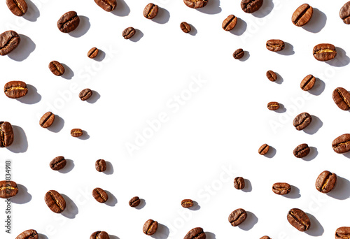 Roasted Coffee beans concept frame on the white background. Top view. Copy space