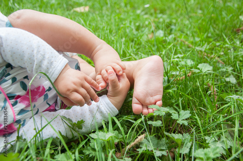Baby feet and hands in the grass
