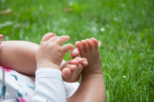 baby feet and hand in grass