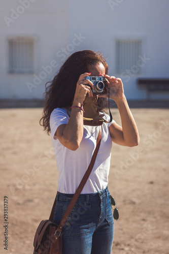 Photographer taking a picture with her old analog photography camera