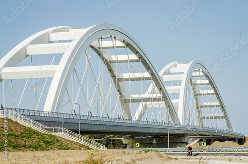 Novi Sad, Serbia - July 17. 2019: Zezelj bridge on river Danube in Novi Sad Serbia. The prospect of built New Zezelj Bridge viewed from the Petrovaradin side of the promenade © caocao191