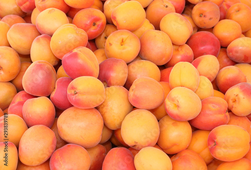 background of ripe apricots for sale at market