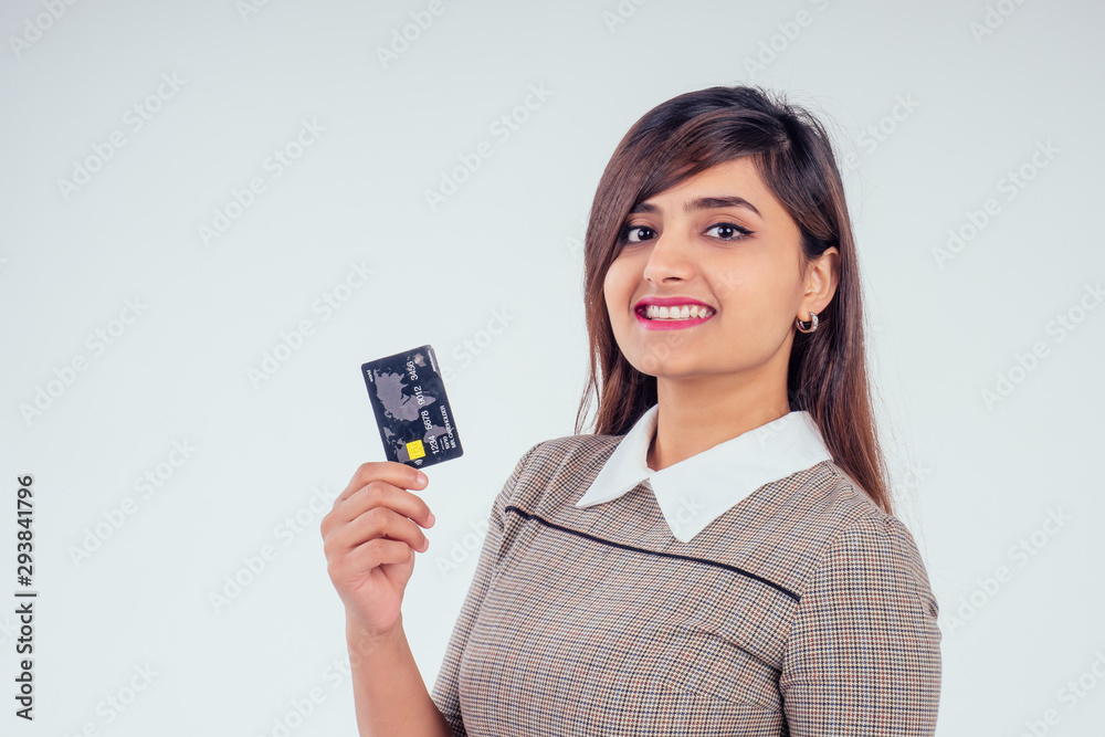 happy indian girl holding credit card in studio white background happy indian girl holding credit card in studio white background