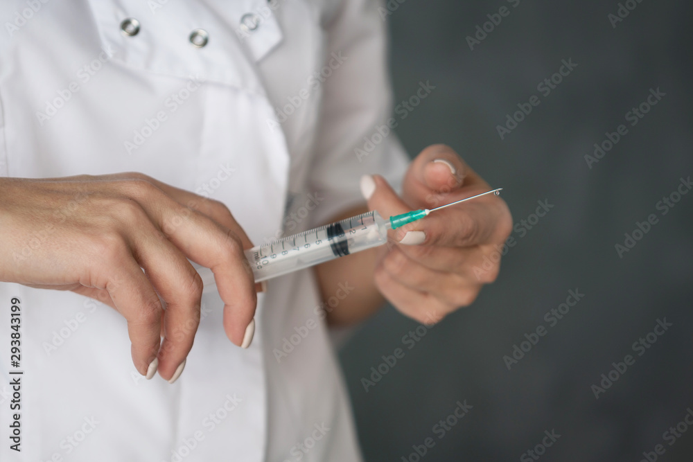 syringe in the hands of a nurse in a white coat syringe in the hands of a nurse in a white coat