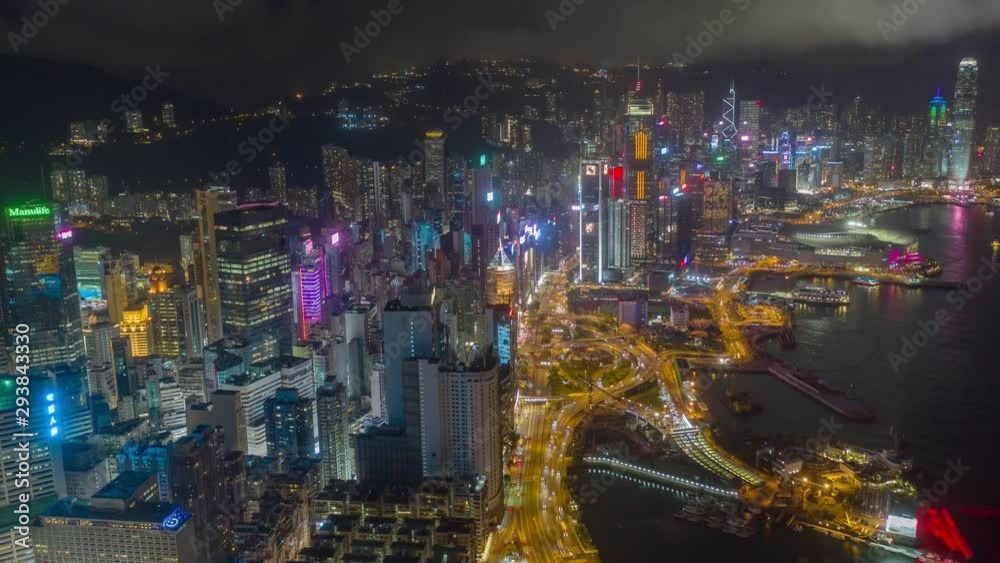 Aerial drone hyper lapse or time lapse over Hong Kong Victoria Habour at night. Central distinct of Hong Kong shot by 4K resolution drone, Hong Kong is the most densely populated place in the world.