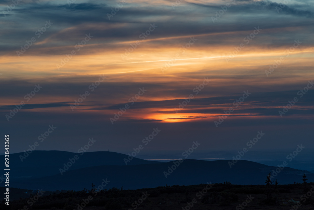 sunset with clouds and colorful sky from Snezne jamy in Krkonose mountains on czech - polish borders