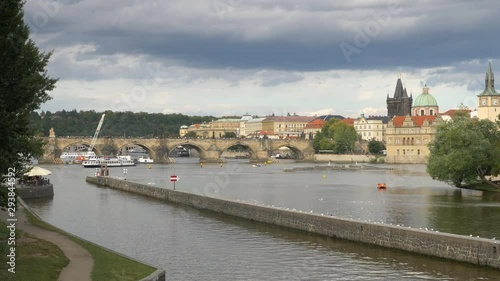 Prague; the Vtala River and Charles Bridge. 4K 50fps fixed video footage looking over the Vtala River in Prague, Czech Republic, towards the famous Charles Bridge landmark and Old Town architecture.