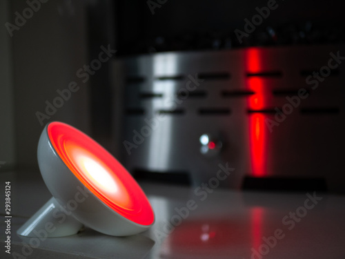 Smart home lamp light with coloured LED on fireplace - Red
