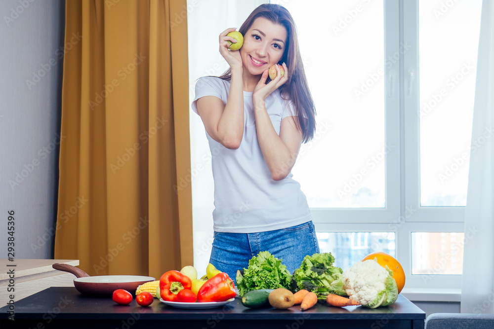 Woman making salad in kitchen ,wearing white t-shirt Woman making salad in kitchen ,wearing white t-shirt