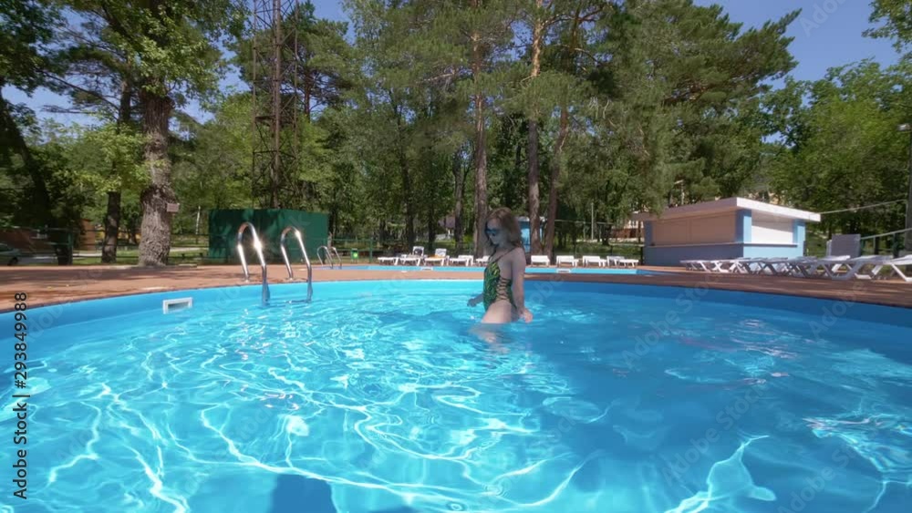 sexy young woman is dancing alone in pool outdoors in sunny summer day sexy young woman is dancing alone in pool outdoors in sunny summer day