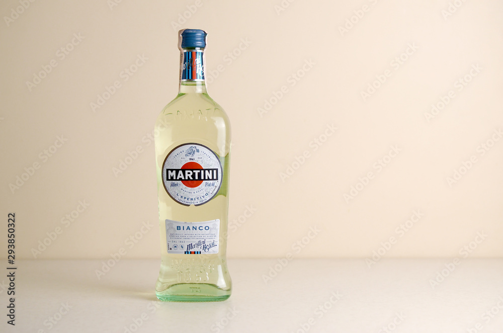 Bottle of Vermouth Martini Rossi close up logo on beige wall background