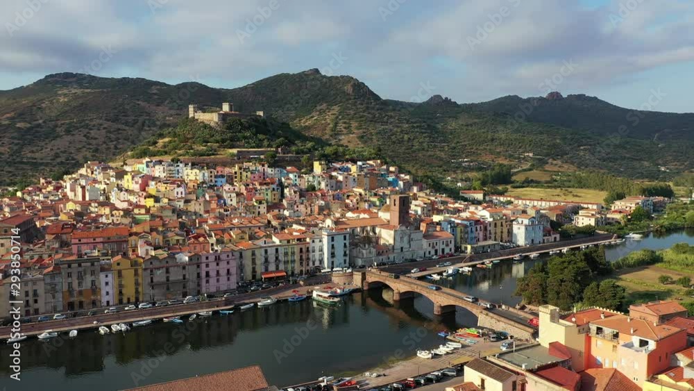 Aerial view of the beautiful village of Bosa with colored houses and a medieval castle. Bosa is located in the north-wesh of Sardinia, Italy. Aerial view of colorful houses in Bosa village, Sardegna. Aerial view of the beautiful village of Bosa with colored houses and a medieval castle. Bosa is located in the north-wesh of Sardinia, Italy. Aerial view of colorful houses in Bosa village, Sardegna.