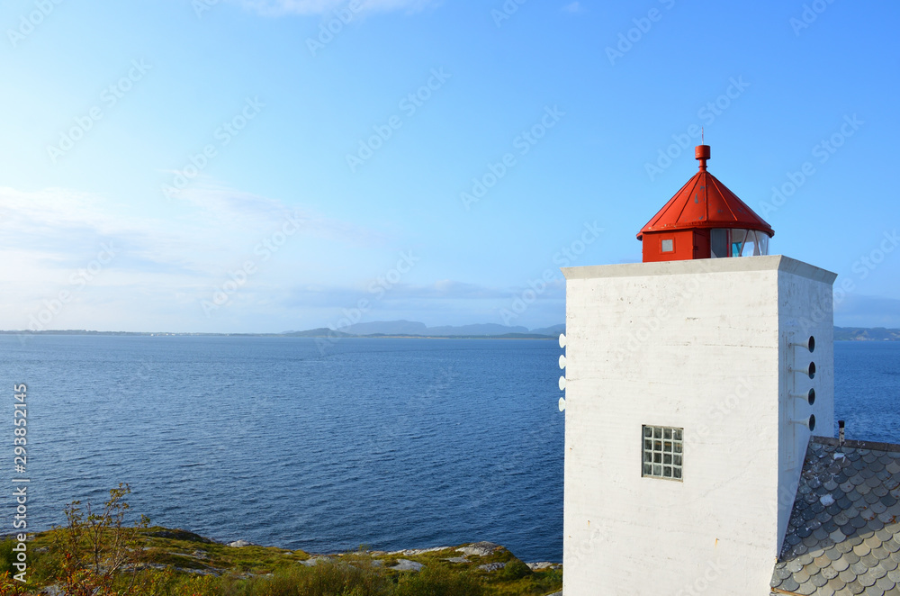 Tranquil Landscape with a Red and White Lighthouse in Norway