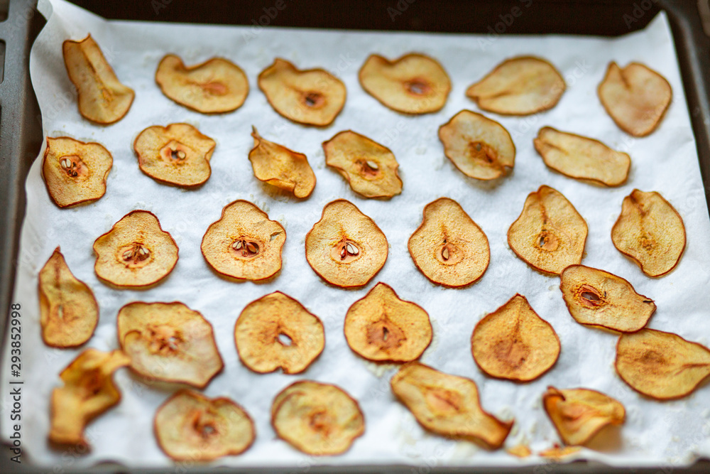 Sweet pear chips. Healthy fruit snack. We bite the chips in the oven from the pear. Vegetarian food. Dessert