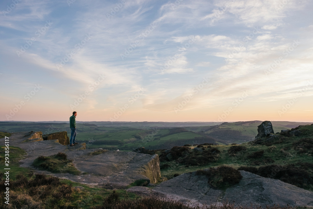 Male enjoying the sunset view from Curbar Edge. Derbyshire, UK. Male enjoying the sunset view from Curbar Edge. Derbyshire, UK.