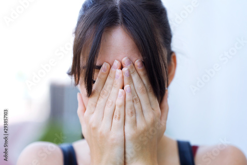 Woman covering face with hands