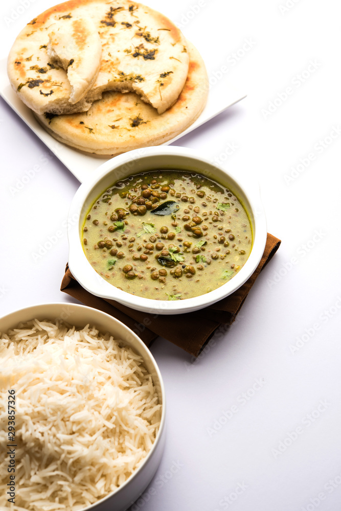 Black Masoor Dal fry or Dhaba Style Sabut Red Lentil dhal tadka in green curry, served in a bowl. selective focus Black Masoor Dal fry or Dhaba Style Sabut Red Lentil dhal tadka in green curry, served in a bowl. selective focus