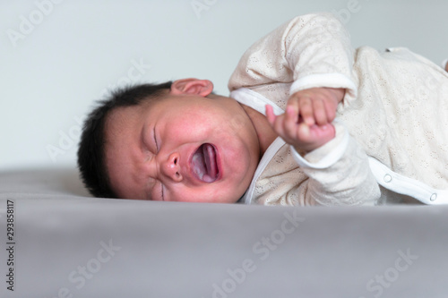 Newborn baby crying at home photo