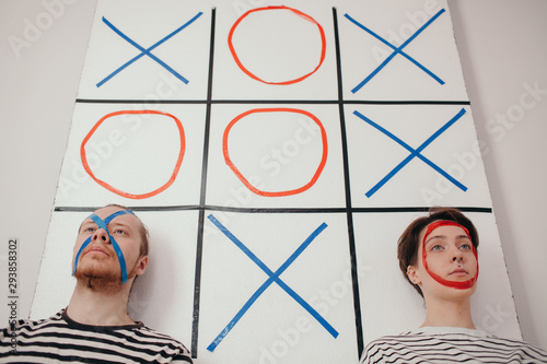 Couple on board with noughts and crosses