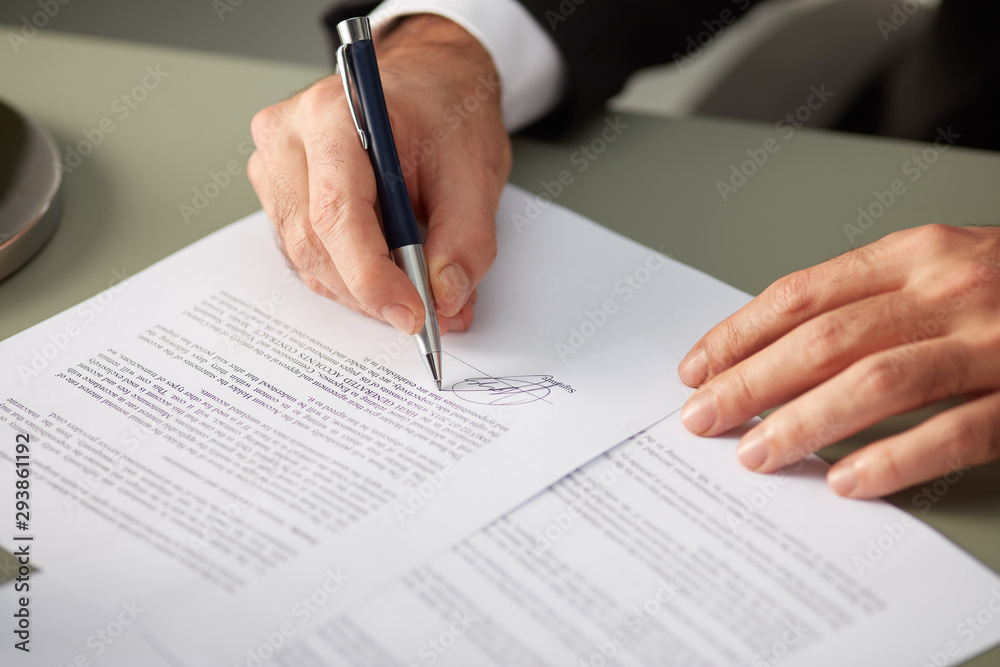 Faceless businessman singing document