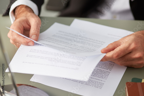 Formal man with paper documents