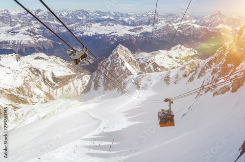 Gondola of cable car in beautiful mountain landscape above a ski resort in winter