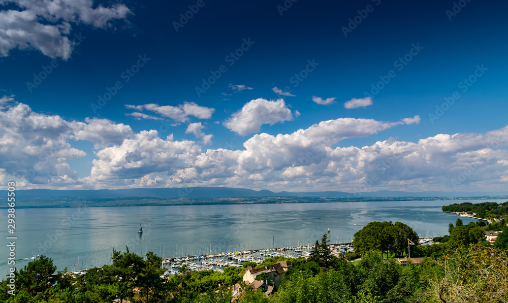 View from the viewpoint of the port of Thonon les Bains, boats, Lake Geneva, and the blue sky with clouds.Haute-Savoie in France.