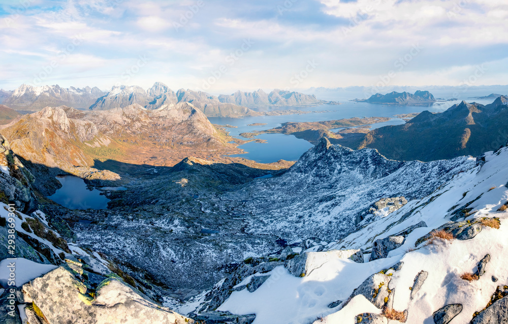 Panorama view from the mountain Rundfjellet to the surrounding snow capped peaks and the sea on the Lofoten Islands, Norway