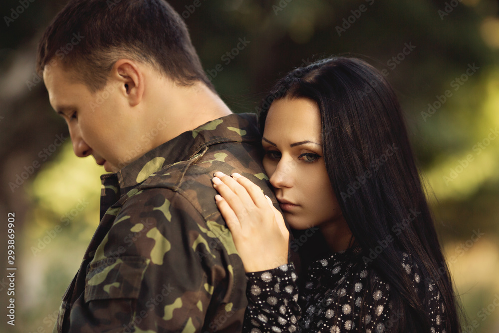Fototapeta premium Family and soldier in a military uniform say goodbye before a separation