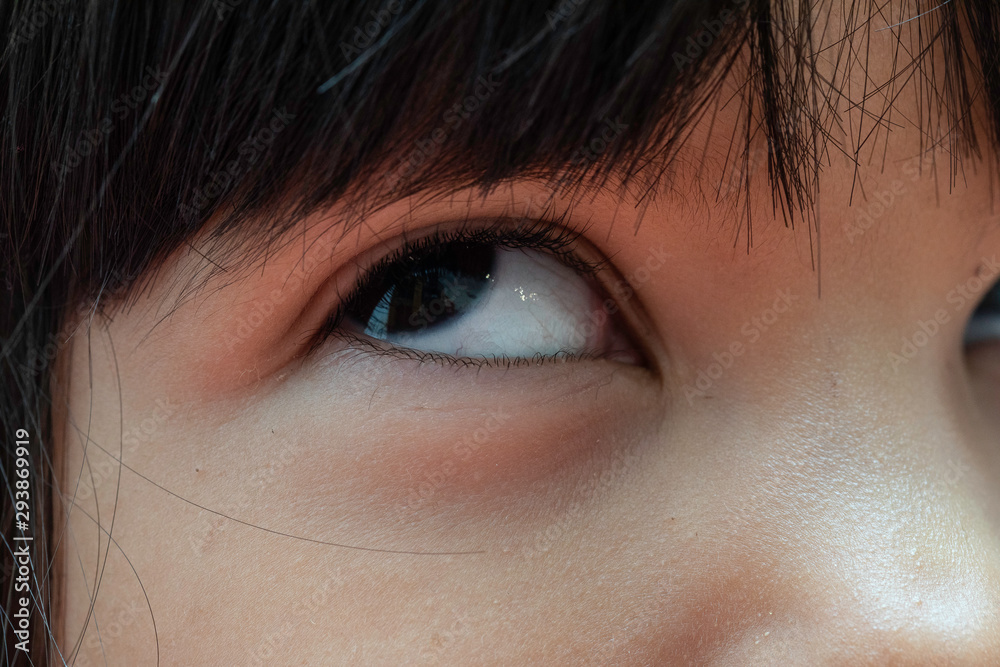 An extreme closeup view on the face of a young child during an