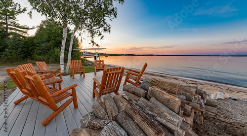table and chairs on the beach with firewood