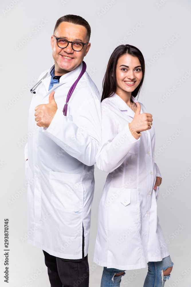 Happy medic workers. Portrait of two doctors in white coats and glasses showing thumb-up against white background Happy medic workers. Portrait of two doctors in white coats and glasses showing thumb-up against white background