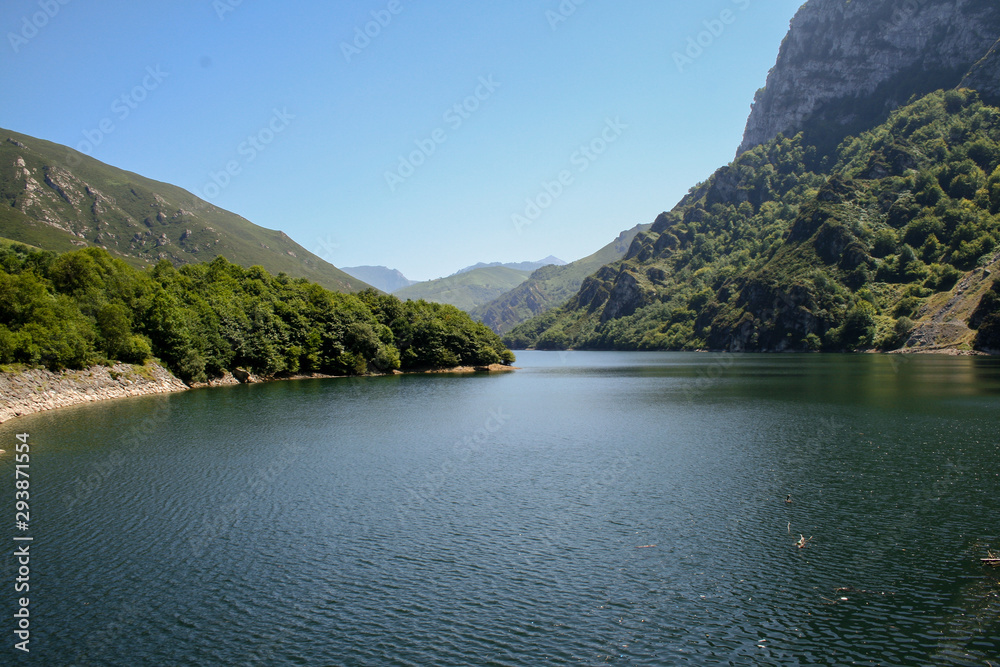 Beautiful landscape of the Porma reservoir Leon surrounded by greenery and mountains on a sunny day Beautiful landscape of the Porma reservoir Leon surrounded by greenery and mountains on a sunny day