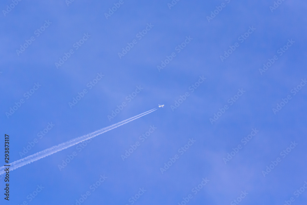 Airplane and vapour trail in the sky