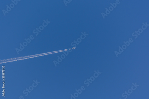 Airplane and vapour trail in the sky