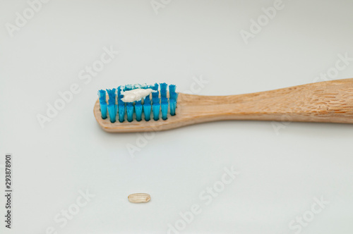 wooden toothbrush with the recommended size of rice grain toothpaste