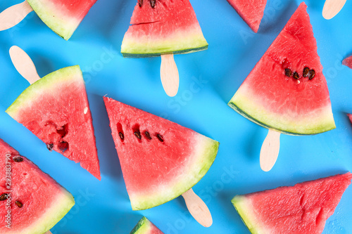  Watermelon slice popsicles on a rustic wood background