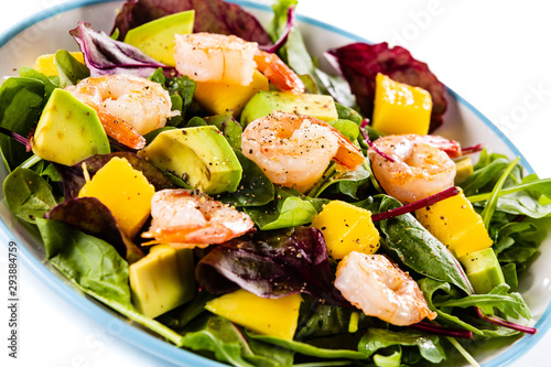 Salad with shrimps on white background