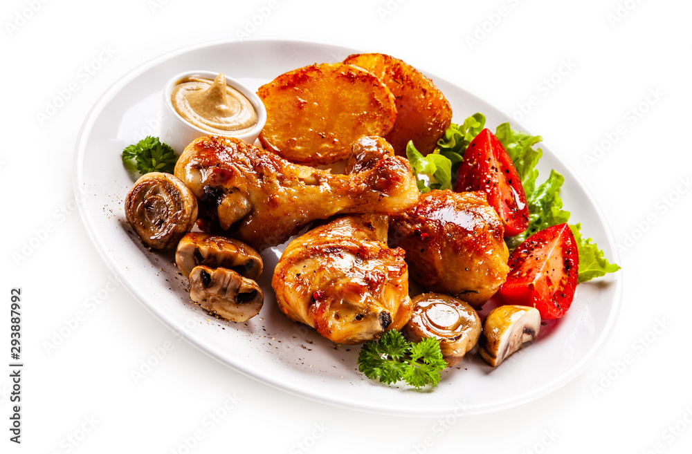 Grilled chicken drumsticks with baked potatoes and vegetables Grilled chicken drumsticks with baked potatoes and vegetables