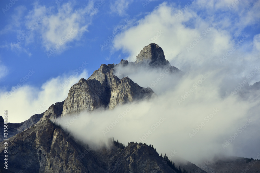 Clouds partially obscuring peak of cascade mountain in Banff national park, Canada.