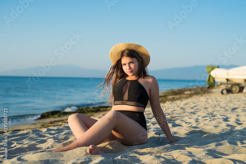 Wallpaper Mural Cheerful plus size teenage girl wearing hat enjoying the beach. smiling, happy, positive emotion, summer style. Torontodigital.ca