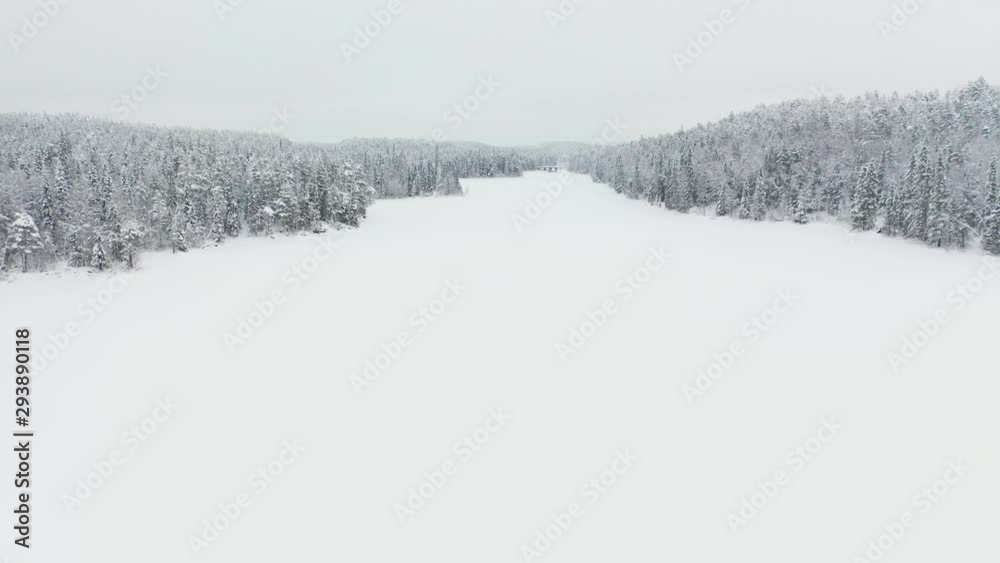 Flying Above Frozen River Under Snow. Aerial View. Northern Karelia, Russia, Paanajärvi Flying Above Frozen River Under Snow. Aerial View. Northern Karelia, Russia, Paanajärvi