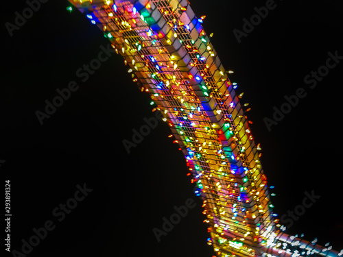 Streak of colorful holiday lights against the dark night