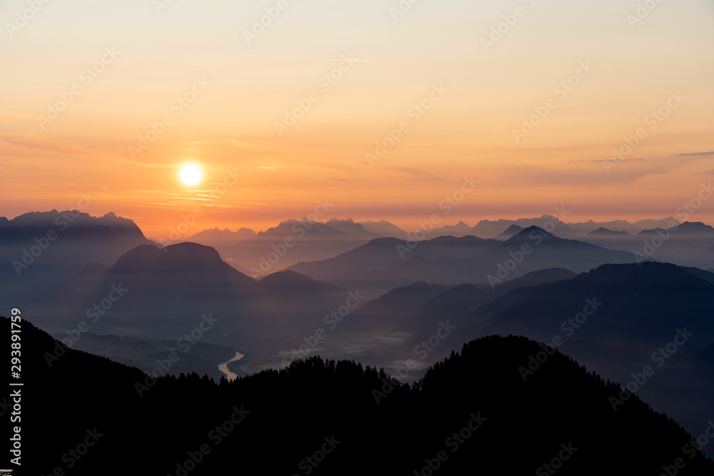 Sunrise over the tyrol alm high over the mountains scenery close up minimal silhouette