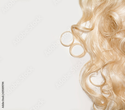 white curly hair on a white background. blonde wig. top view background
